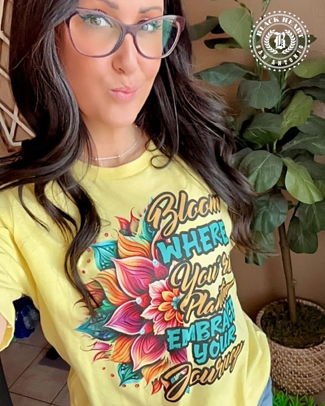 Steph from Arizona (AZ) wearing the yellow Bloom Where You're Planted tee – motivational apparel ad by Black Heart Tees