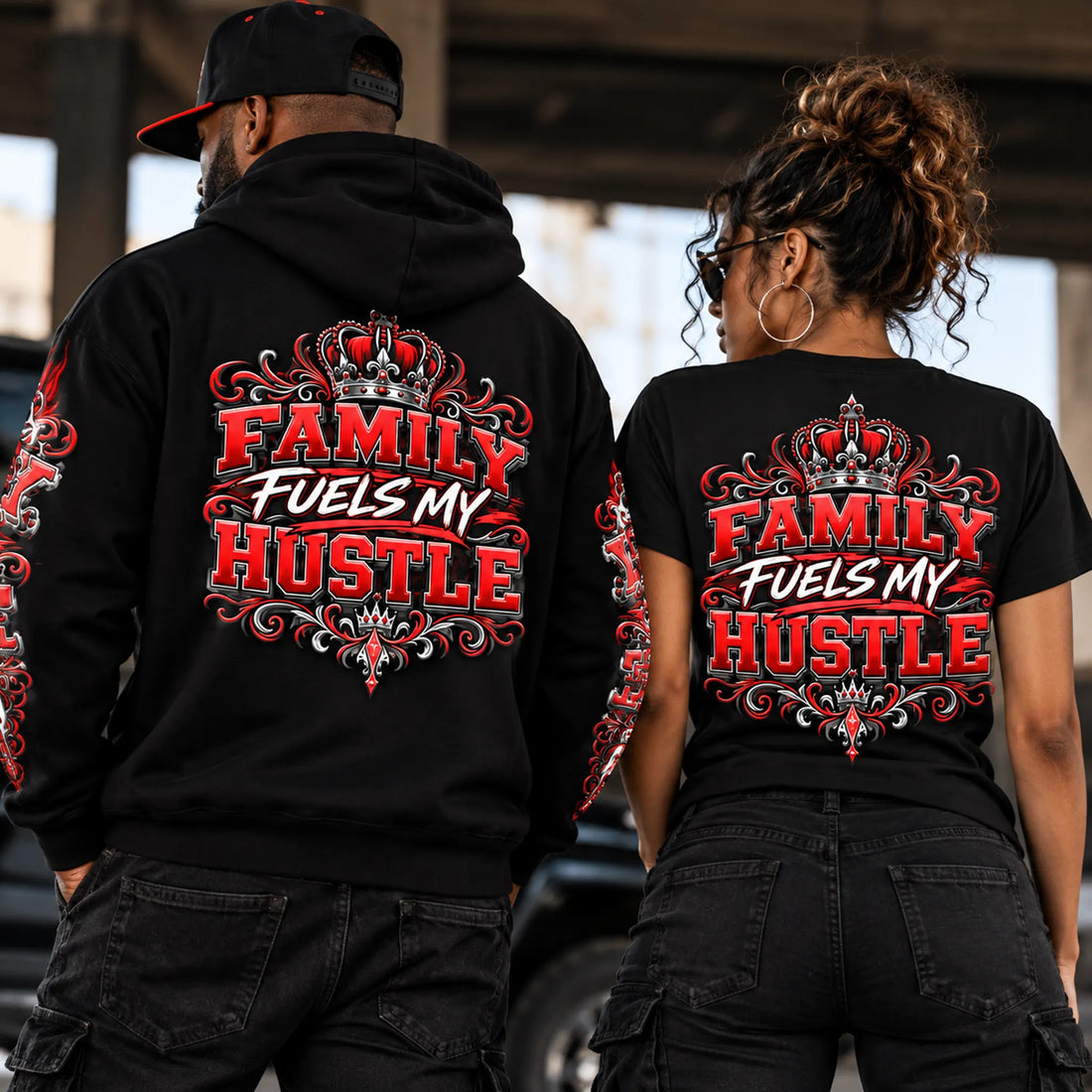Two models wearing black Family Fuels My Hustle graphic hoodie and t-shirt, showcasing bold crowned back designs from Black Heart Tees Clothing's motivational streetwear collection.