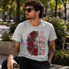 Man wearing Be A Rose In Your Darkness Athletic Heather graphic tee with skull and red roses design in an outdoor lifestyle setting – Black Heart Tees motivational apparel