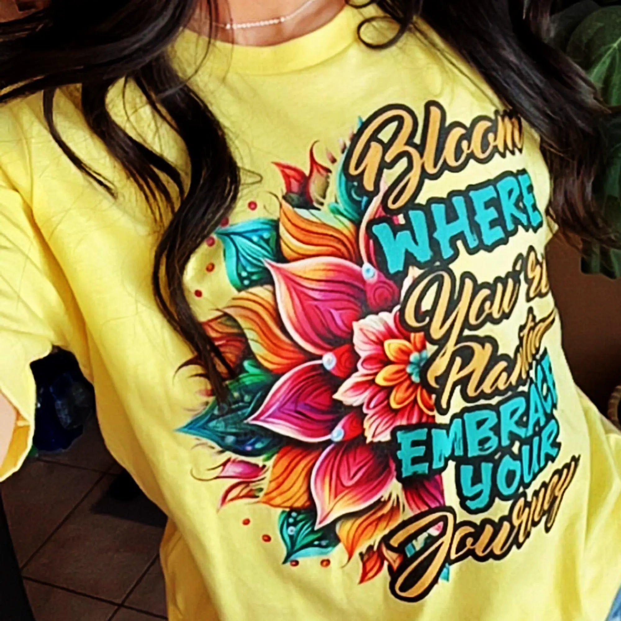 Black Heart Tees Bloom Where You’re Planted T-shirt with vibrant floral artwork with motivational text message
