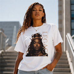 Woman wearing Queen Legacy white graphic tee with crowned portrait design on outdoor urban steps – Black Heart Tees motivational apparel
