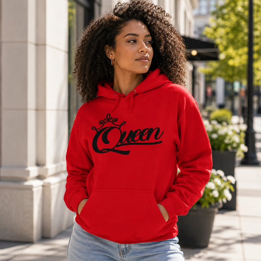 Woman wearing Queen red pullover hoodie with black crown script design in a bright urban setting – Black Heart Tees motivational apparel.